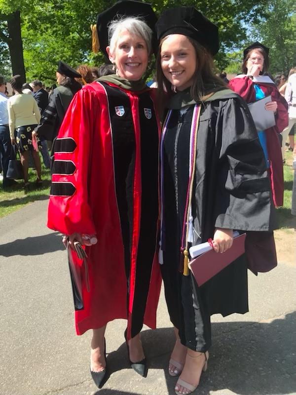 Board member and student stand together at ACPHS commencement